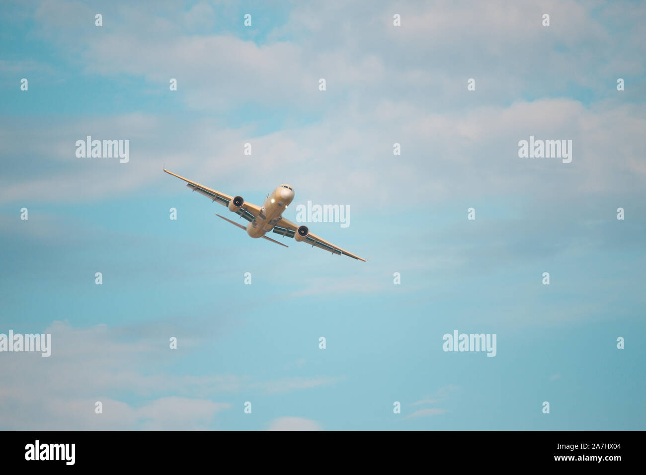 Airplane is flying in the blue sky Stock Photo - Alamy