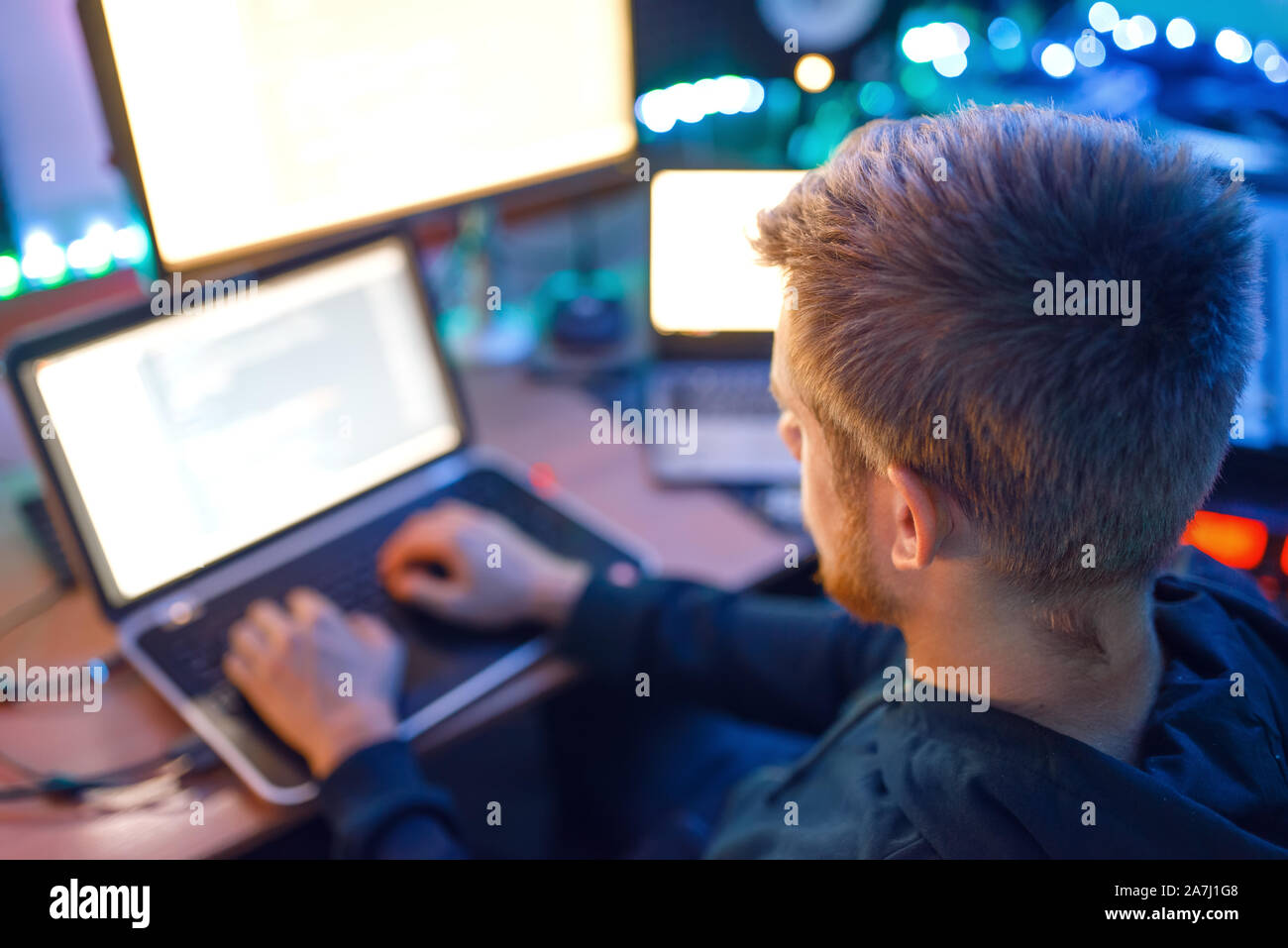 Programmer using laptop and PC, information coding Stock Photo