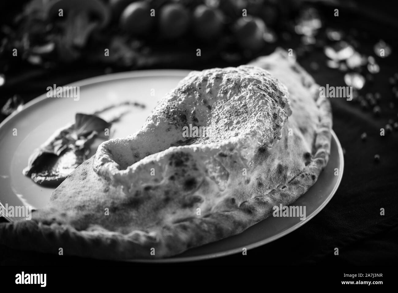 tasty italian calzone pizza dish with fresh ingredients Stock Photo