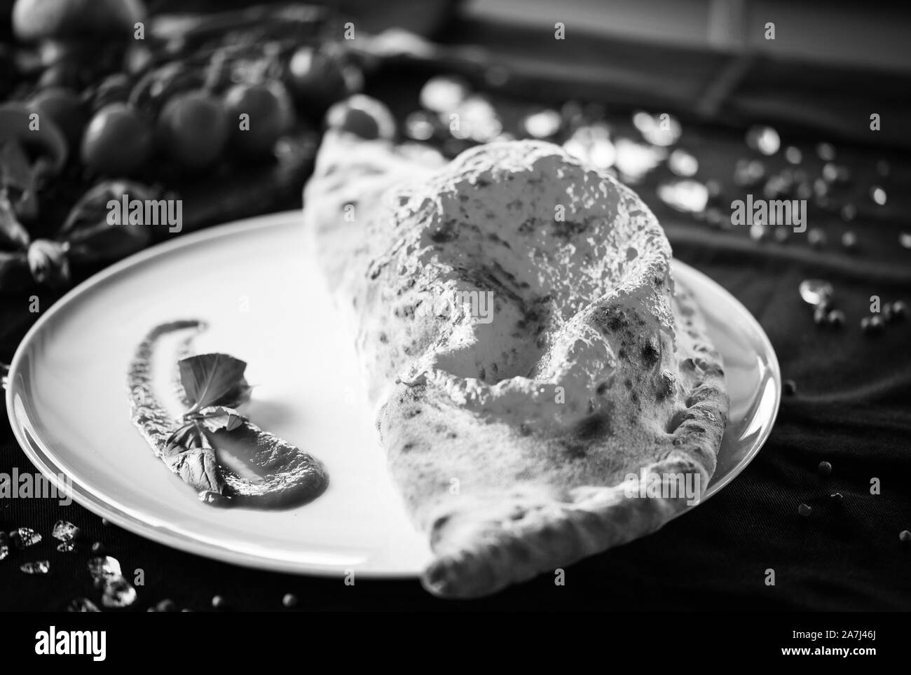 tasty italian calzone pizza dish with fresh ingredients Stock Photo - Alamy