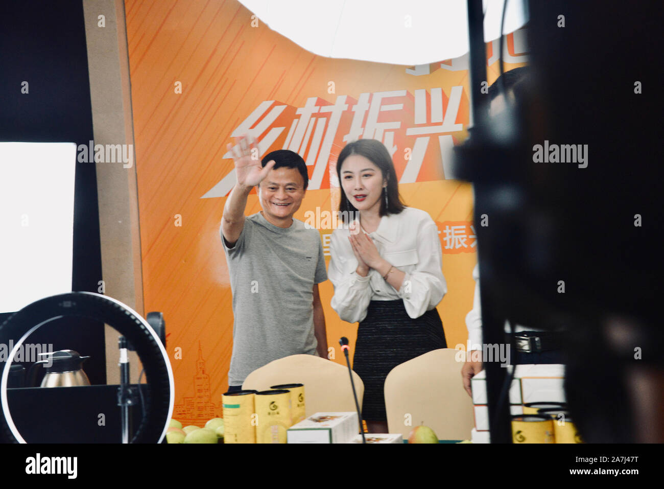 Jack Ma, left, waves at the camera at the online host Kikis live-streaming event for selling Binzhou farm products in Binzhou city, east Chinas Shan Stock Photo