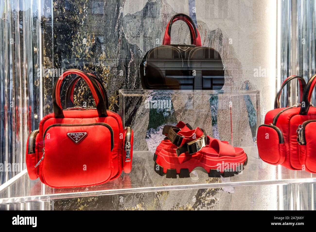 A shopper with a Prada shopping bag on Bleecker Street in Greenwich Village  in New York Stock Photo - Alamy