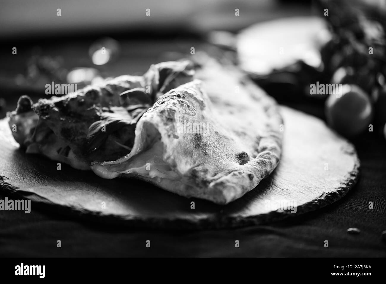 tasty italian calzone pizza dish with fresh ingredients Stock Photo