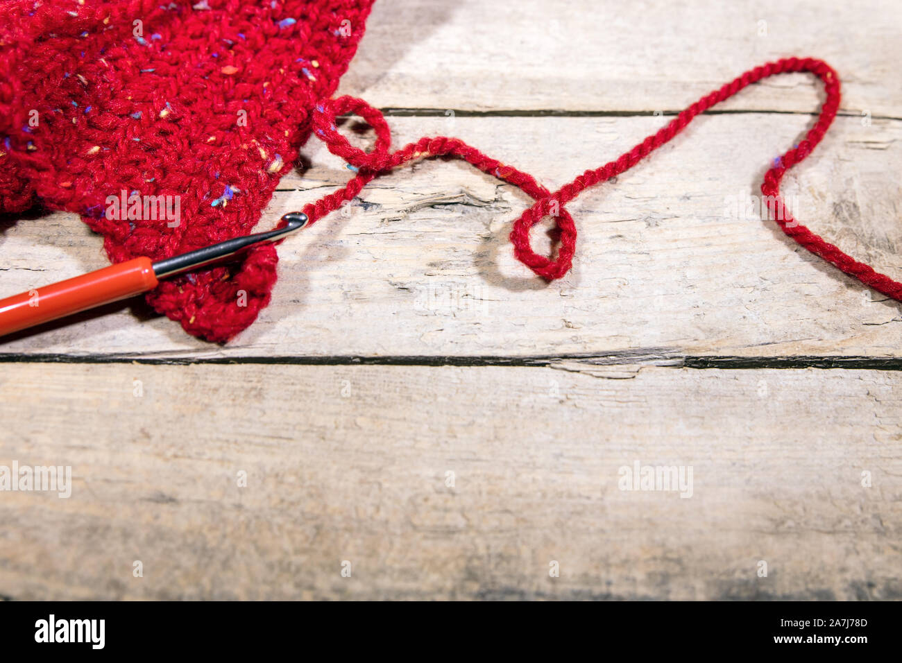red woollen string and chrochet hook on wood, Hobby Handiwork ...