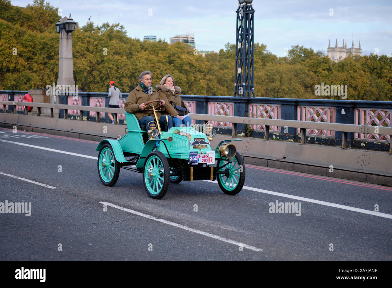 London, UK. 3rd November 2019. Participants driving a 1904 Pope-Tribune crossing the Thames driving on Lambeth Bridge overlooked by Westminster Palace in this year’s edition of the Bonhams London to Brighton Veteran Car Run. Credit: JF Pelletier / Alamy Live News Stock Photo
