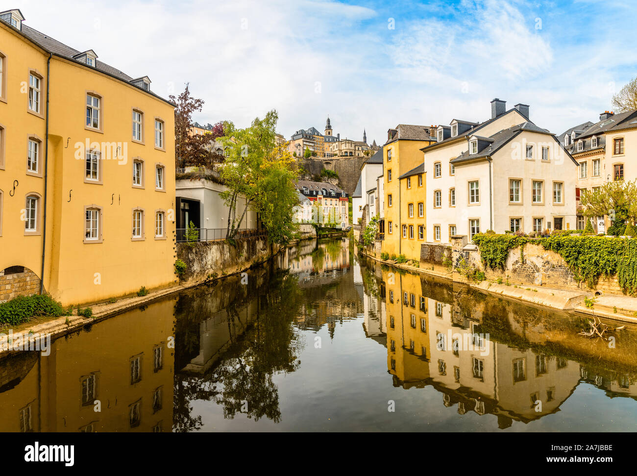 Alzette river bend with houses reflected in water and cathedral on the hill, Luxembourg city, Luxembourg Stock Photo