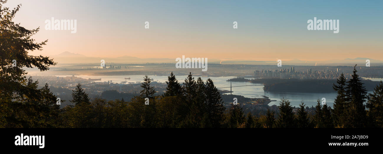 A sunrise view of downtown Vancouver, Stanley Park, and the Lions Gate Bridge as seen from Cypress Mountain. Stock Photo