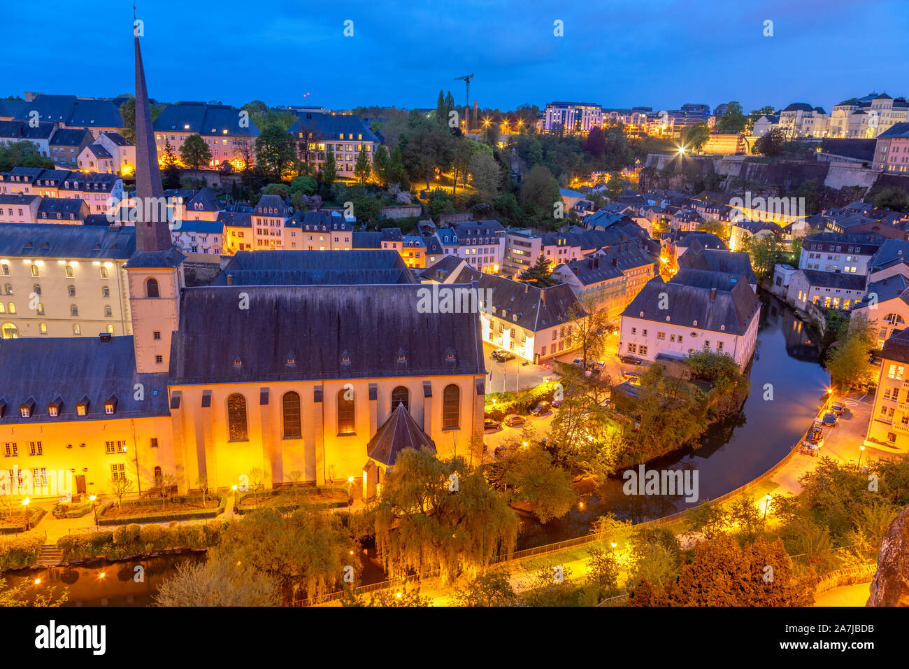 Alzette river bend with Saint Jean Du Grund cathedral and row of the houses behind, Luxembourg city, Luxembourg Stock Photo