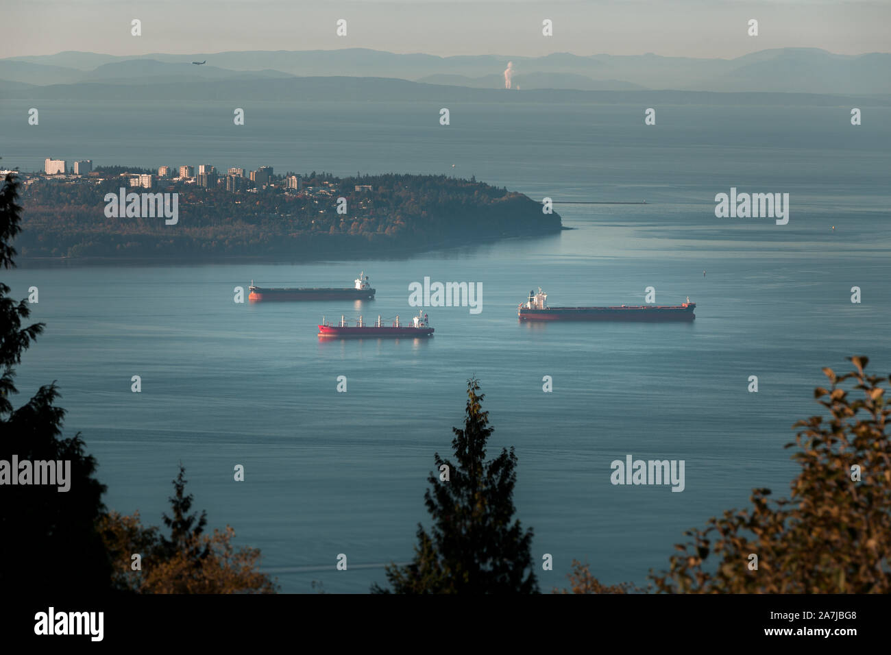 Cargo ships anchored in Burrard Inlet near Point Grey in Vancouver, BC. Stock Photo