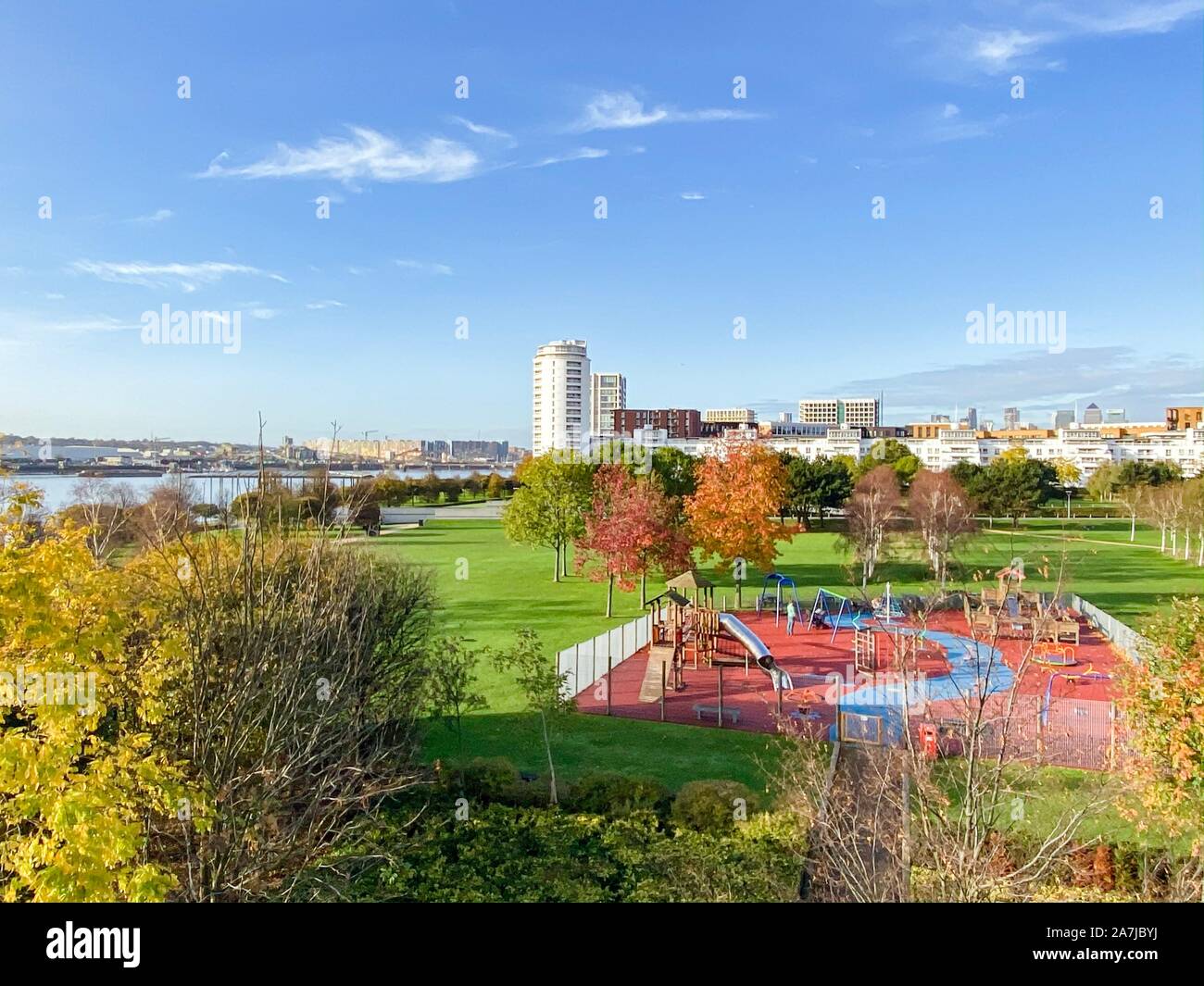 Silvertown, London, UK. 3rd Nov, 2019. UK Weather: Blue skies over Thames barrier park with Royal Wharf and Canary wharf skyline. Credit: WansfordPhoto/Alamy Live News Stock Photo