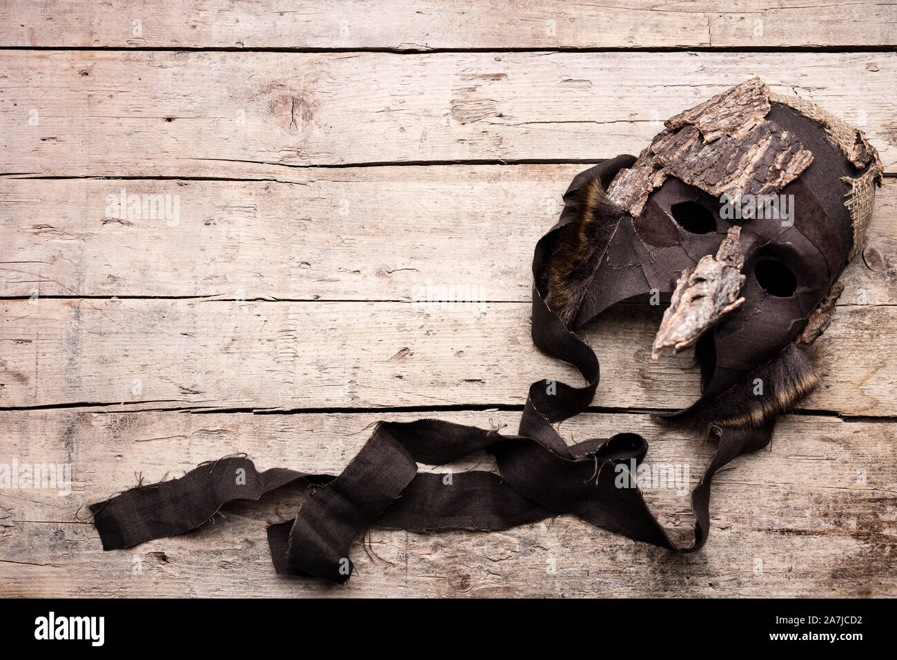 Mask on wooden background, costume and masquerade for theatre, copyspace Stock Photo