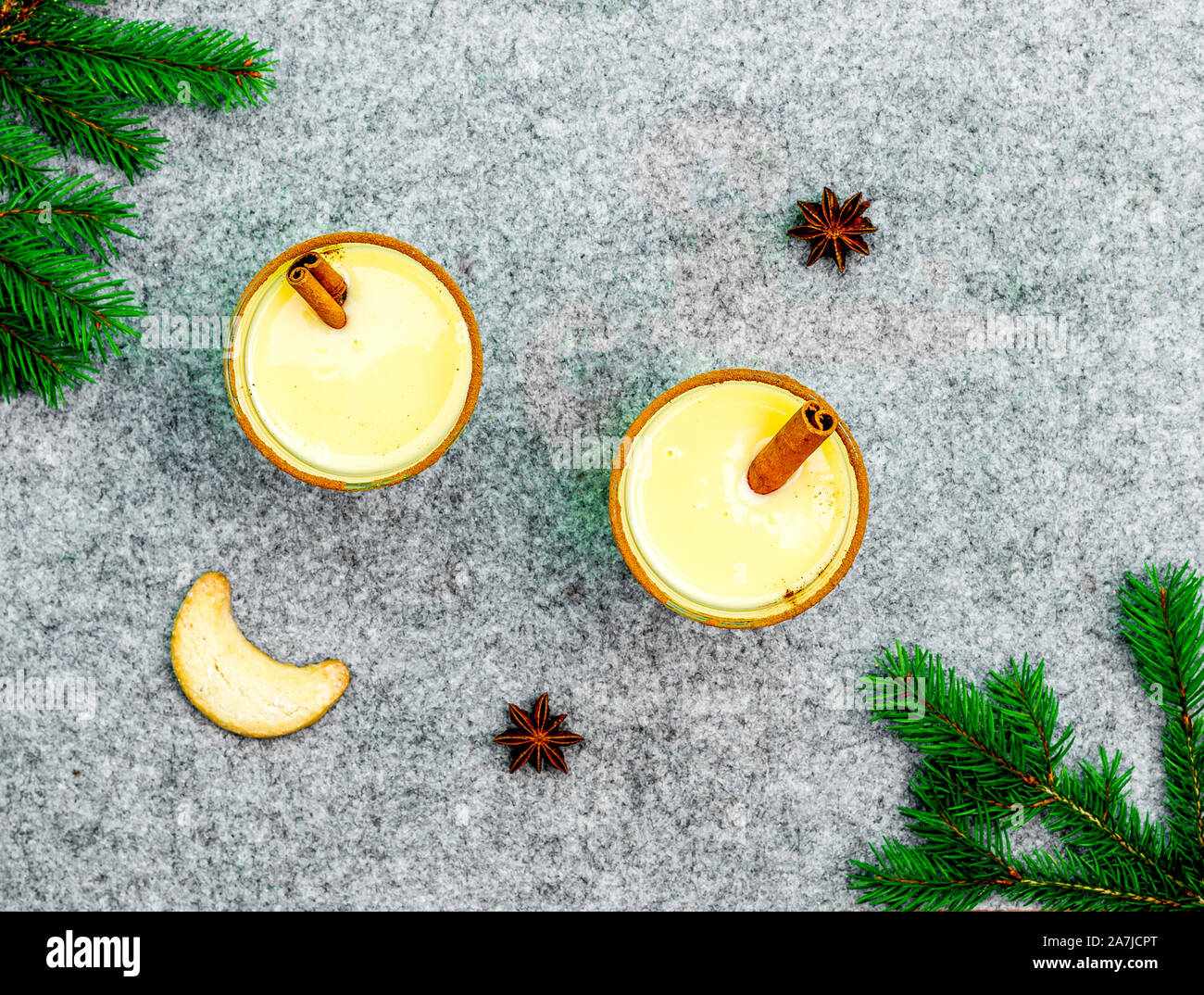 Two eggnog glasses on grey felt, top view Stock Photo