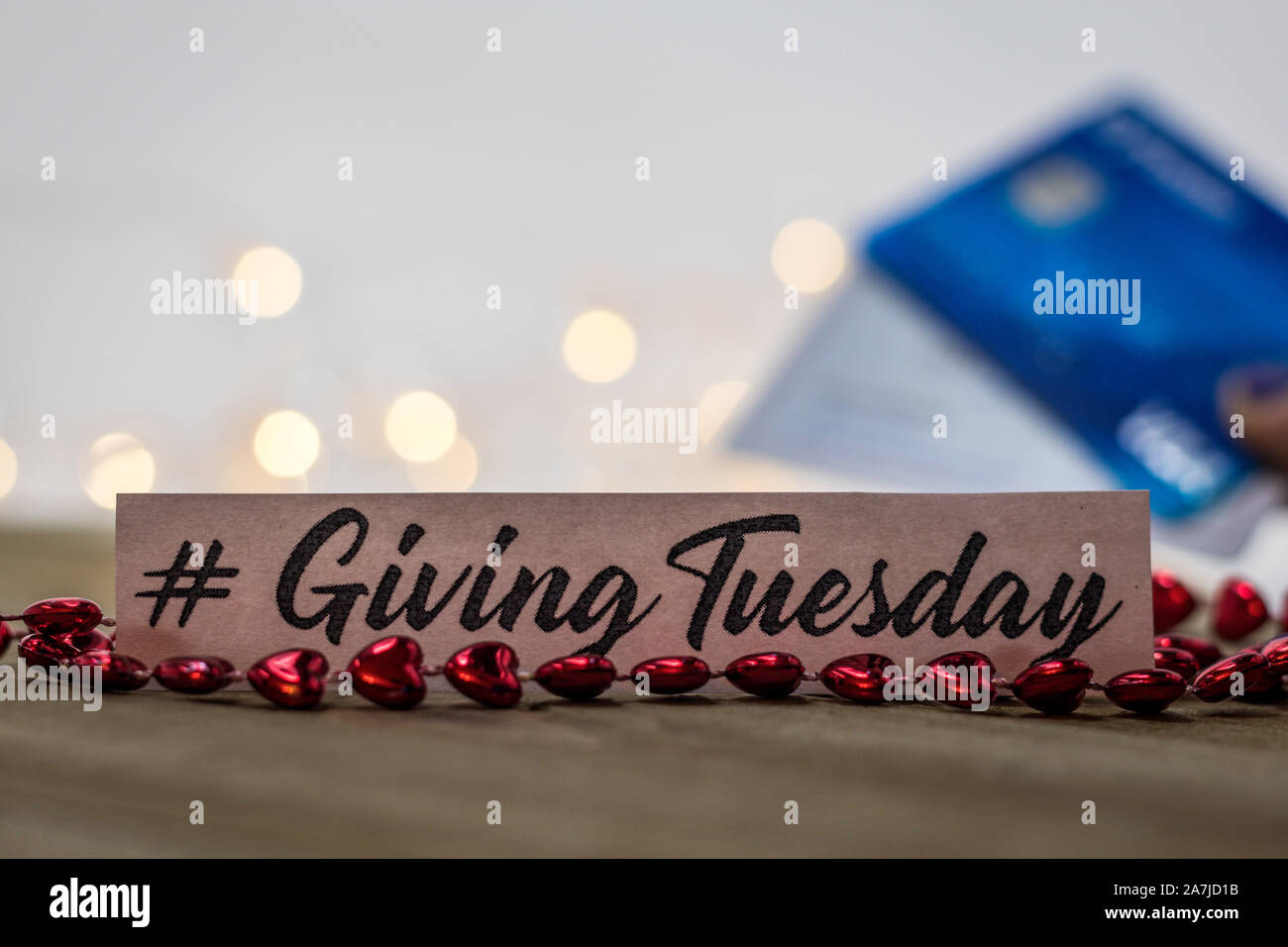 Giving Tuesday donate charity concept with text and cash credit cards on wooden board Stock Photo
