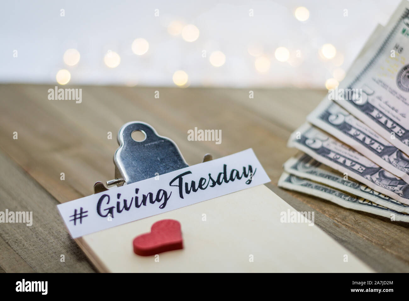 Giving Tuesday donate charity concept with text and cash credit cards on wooden board Stock Photo