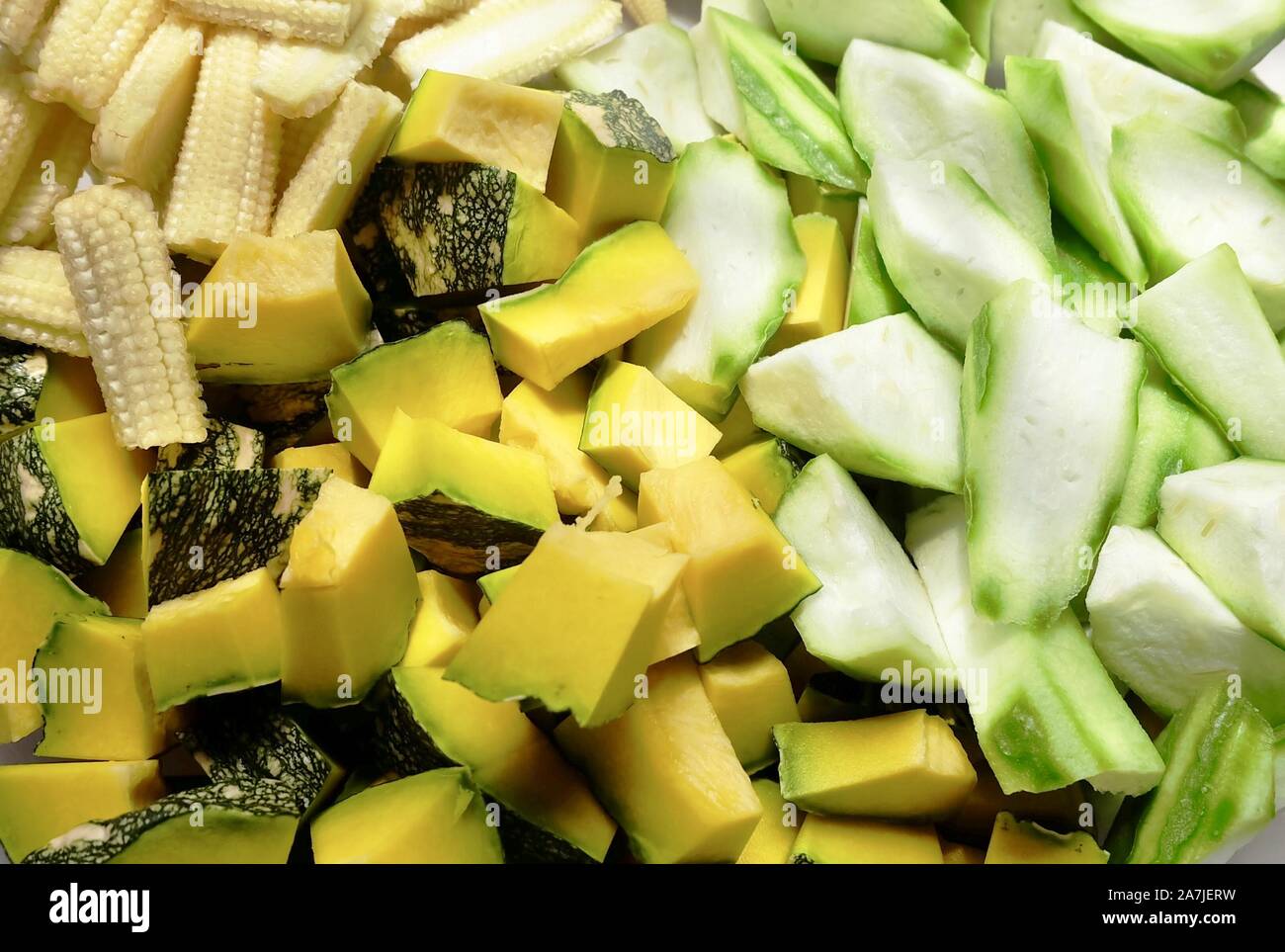Vegetable, Closeup Raw Chopped Pumpkins, Angled Gourds or Sponge Gourds and Baby Corns. Stock Photo