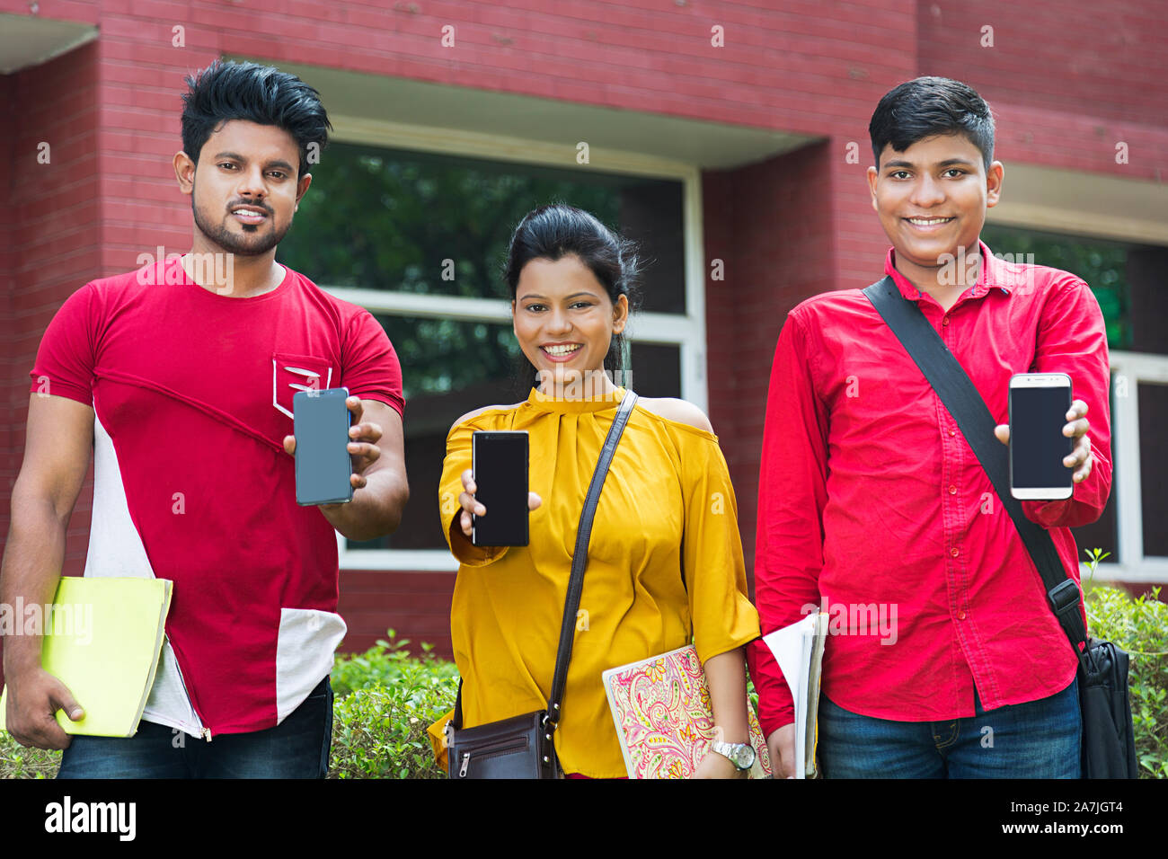 College University Students Classmates Together Showing Cell-phone Advance Technology In-Outside Campus Building Stock Photo