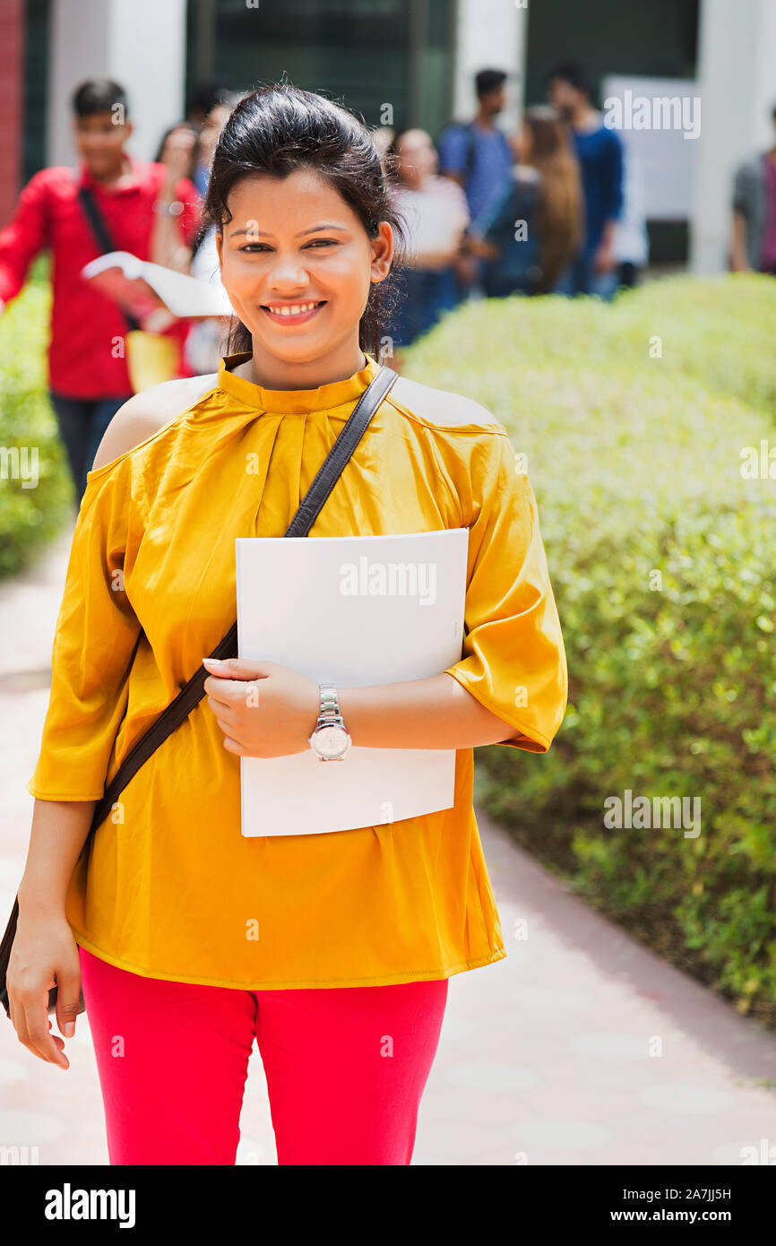 Happy Teenager girl College Student Carrying Bag And Holding Book