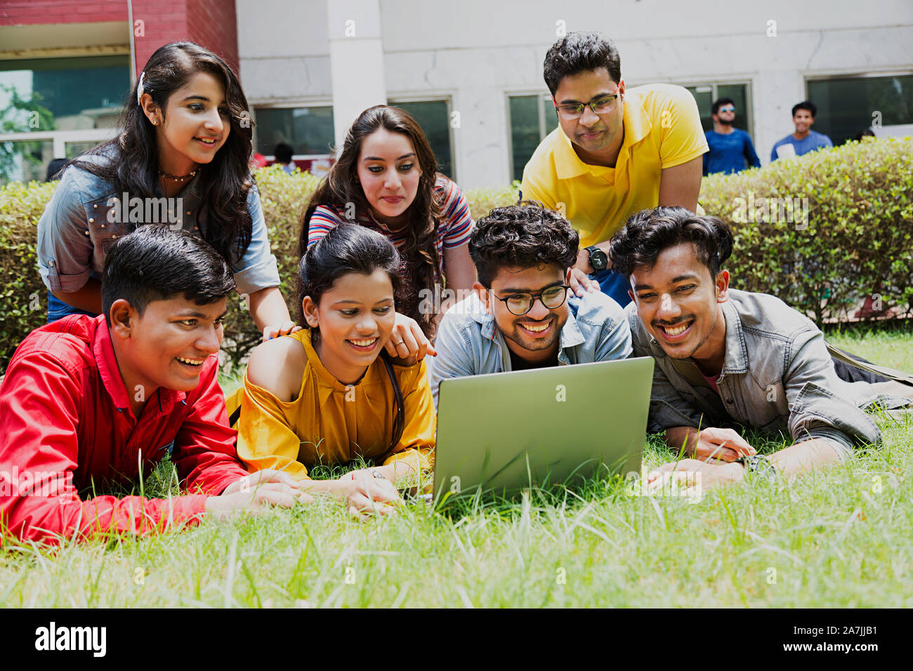 Group Of College Boys And Girls Students Friends Together Looking-At laptop Screen In-Outside Campus Stock Photo