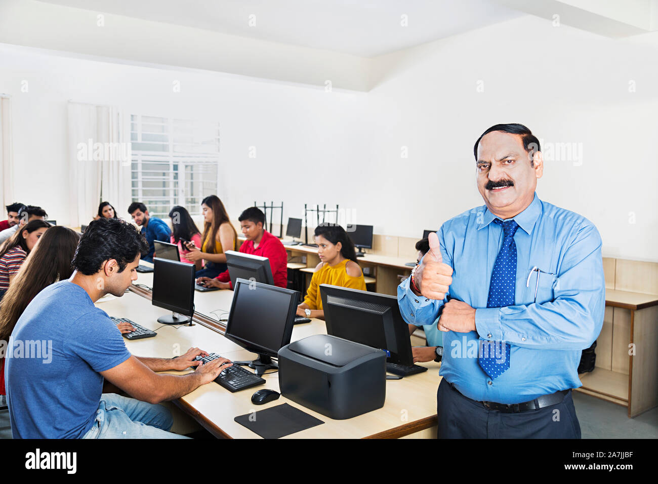 Senior male College Professor Showing thumbsup With Students Studying