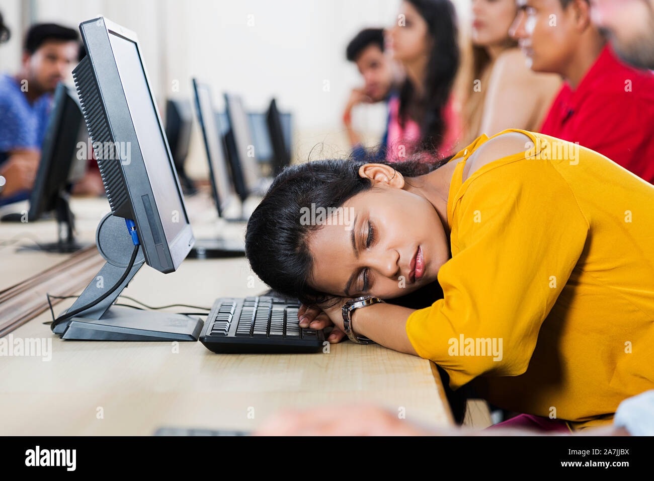 Tired Young Woman College Student Sleeping On The Table With Computer In Classroom Stock Photo