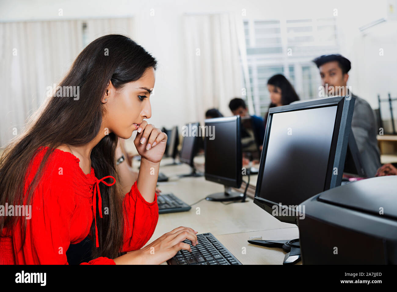 Teenager girl College Student Using Computer Studying E-Learning With Classmates At Computer Class Stock Photo