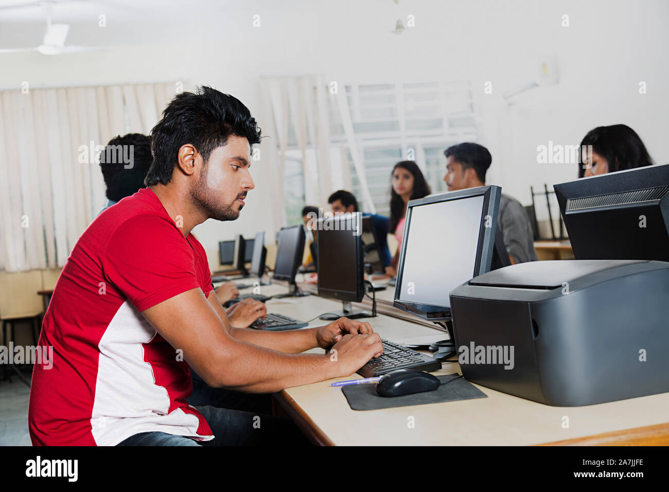 Young Male College Student Working On Computer Studying E-Learning With ...