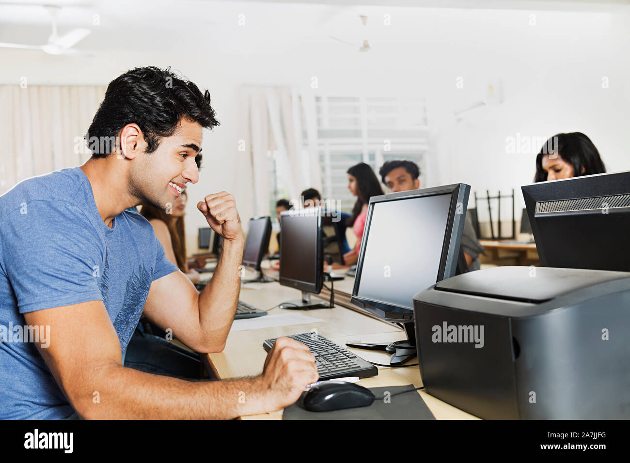 Young Male College Student Using Computer Studying E-Learning With ...
