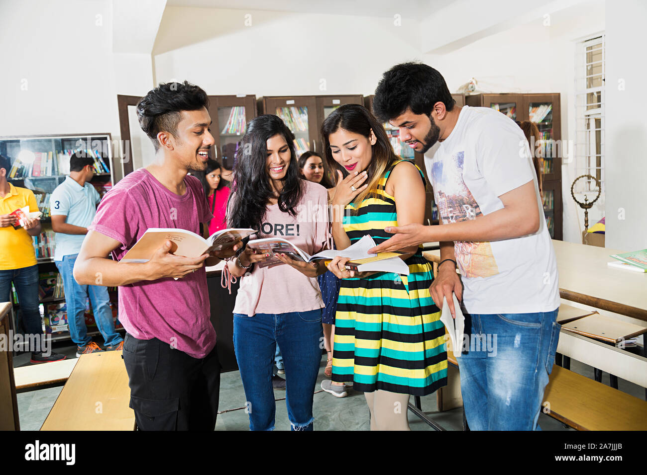 Four College Students Friends Reading Book Studying Education In-Library Preparing Exam Test Stock Photo