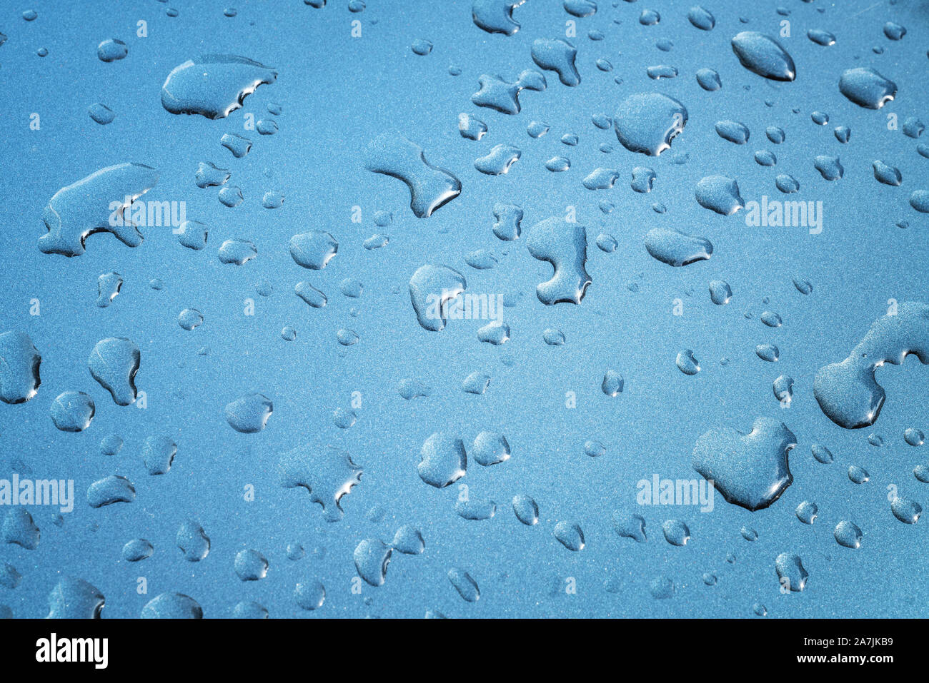 rain drops are spreaded on a meatllic surface for background. Stock Photo
