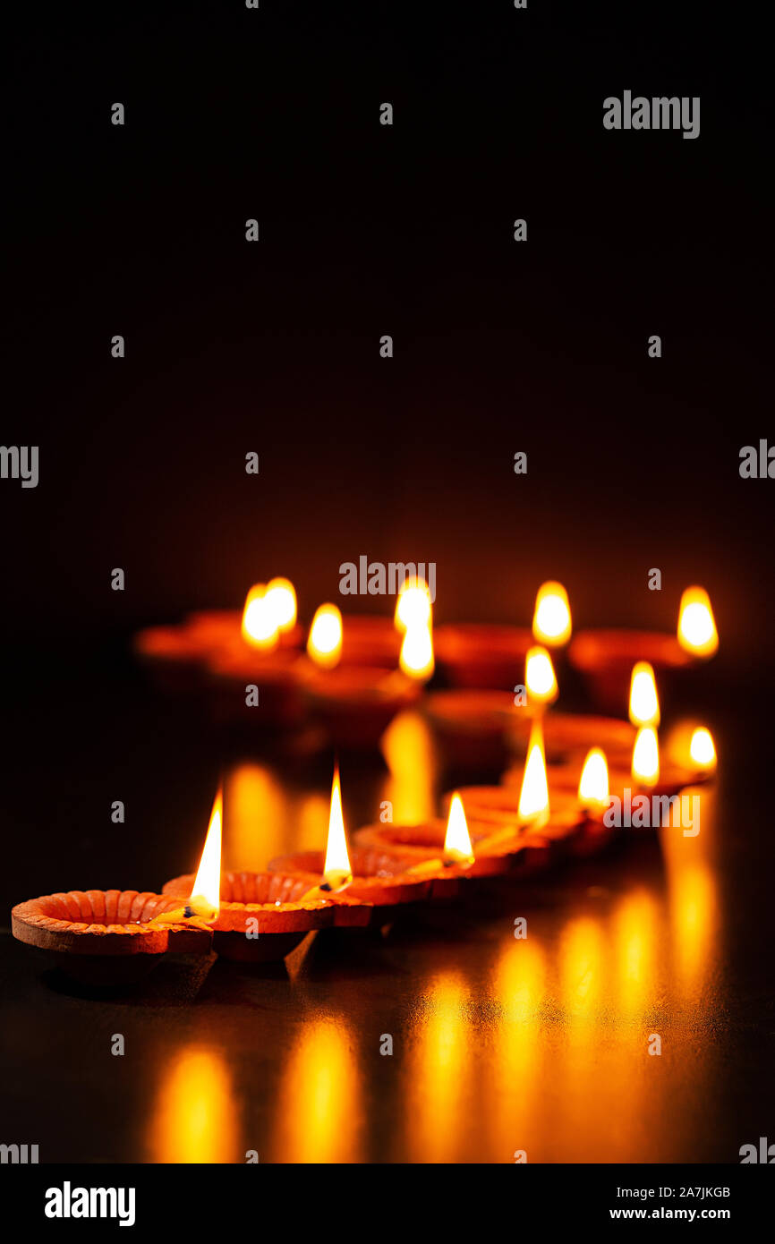 Large group of-burning Candles Arranging Queues During Diwali Festival Celebration Stock Photo