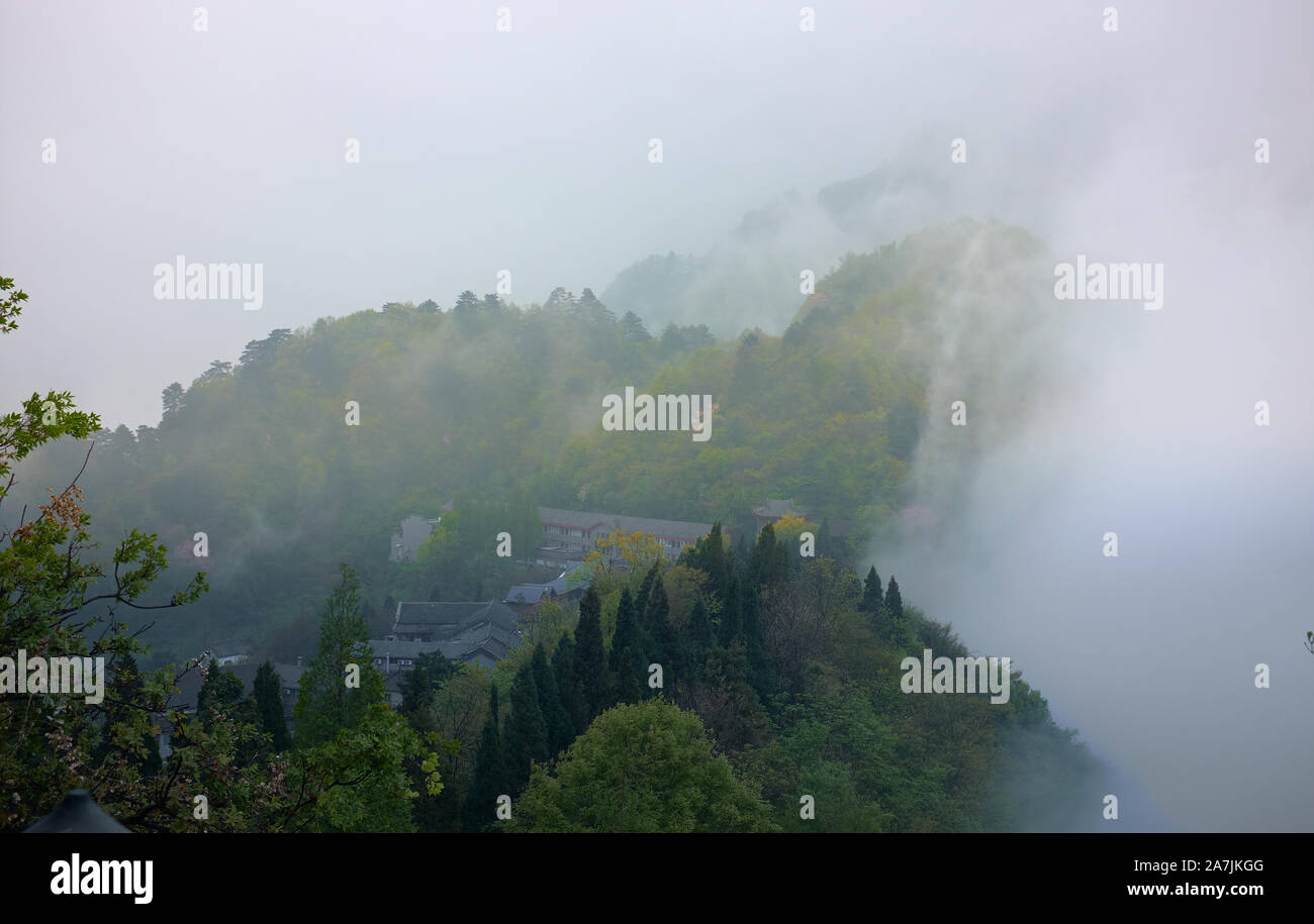 The clouds down from the peack of Wudang mountain to the ancien Chinese temple. Stock Photo