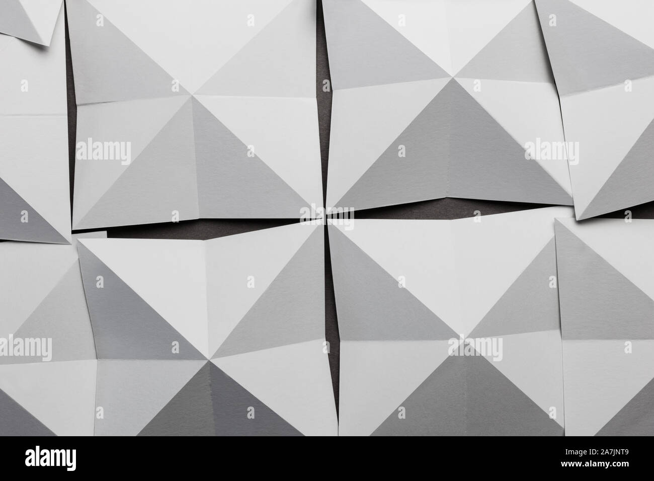White paper folded in geometric shapes, abstract background Stock Photo