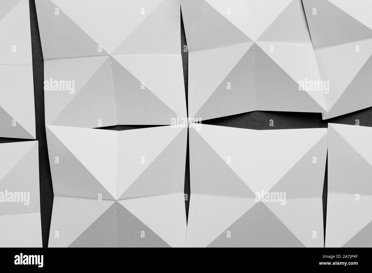 White paper folded in geometric shapes, abstract background Stock Photo