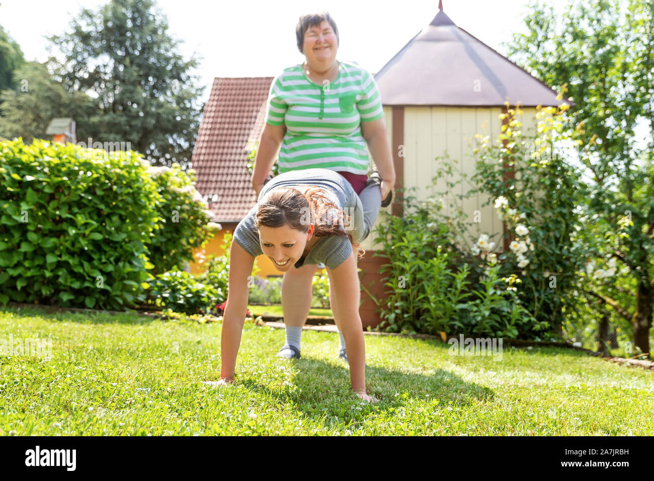 mentally disabled woman is doing exercises with an therapist or trainer, maybe a good friend. Stock Photo