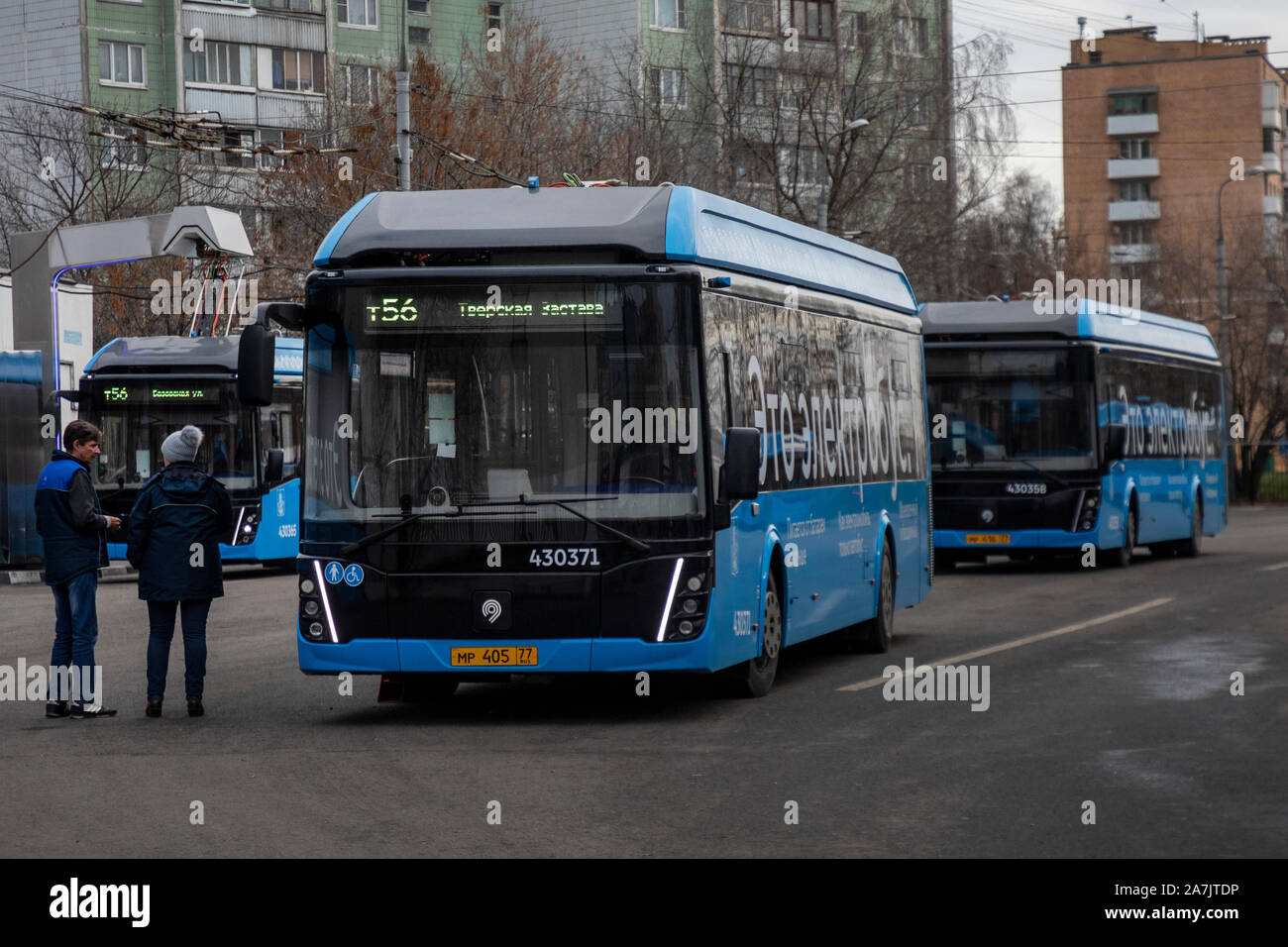Electric buses stand in line to charge batteries at the terminal station in Moscow, Russia Stock Photo