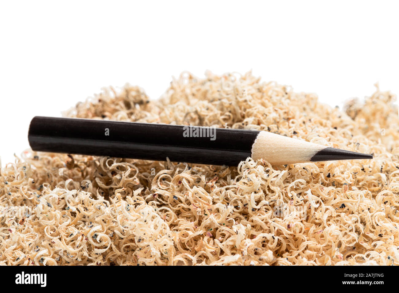 Oversharpened  pencil in front of the heap of shavings. Concept of the fruitless design or art work Stock Photo