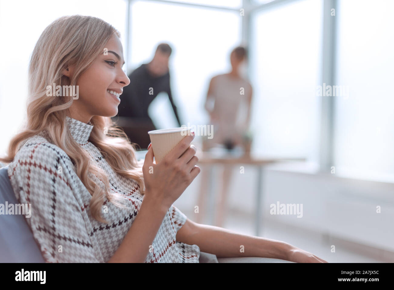young business woman with a Cup of coffee in a modern office Stock Photo