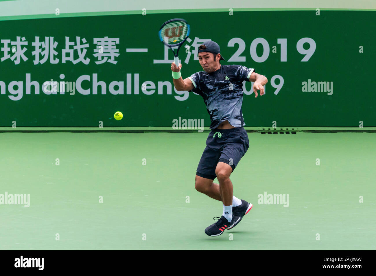 Japanese tennis player Yasutaka Uchiyama catches the ball at the