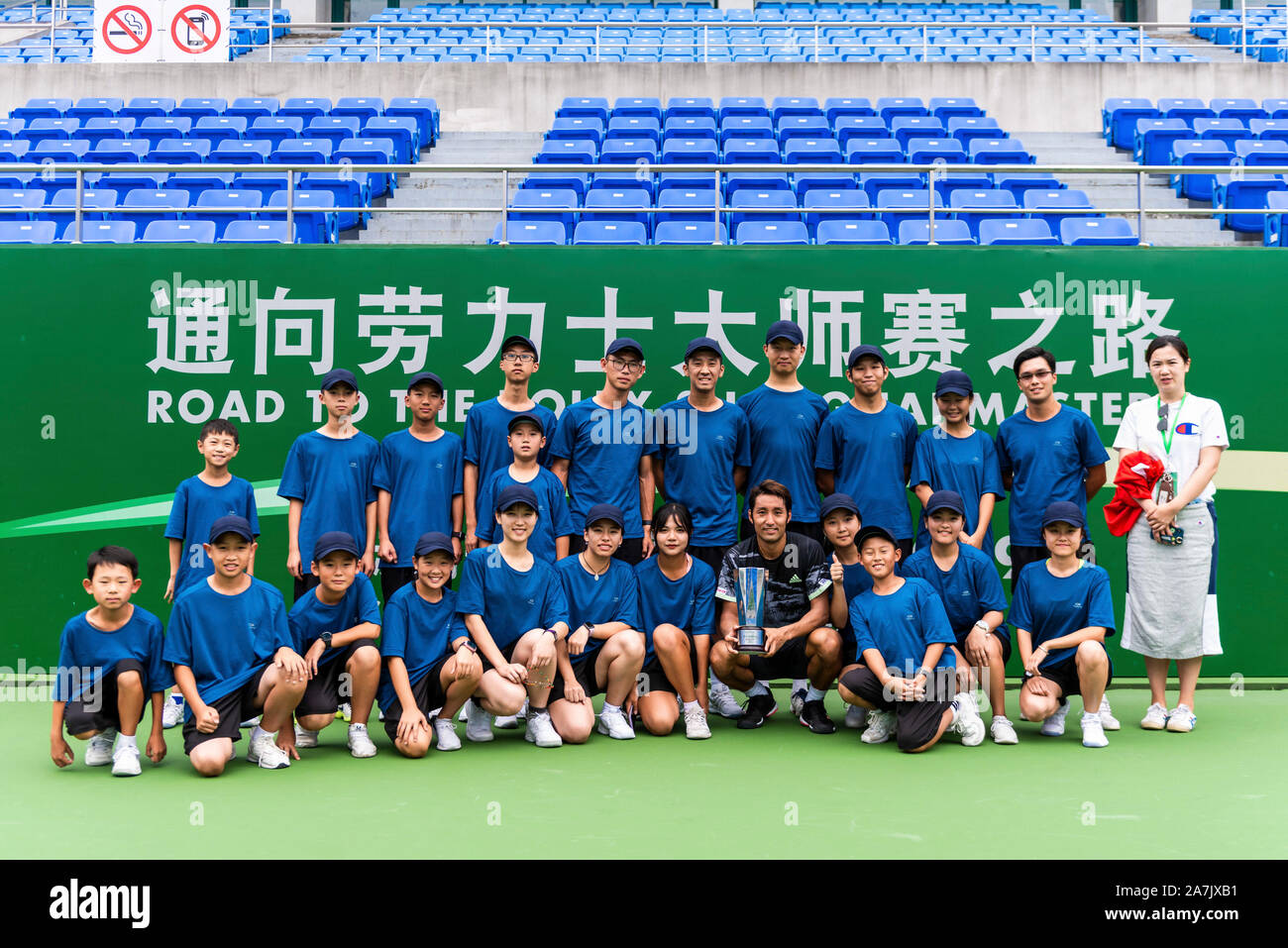 Japanese tennis player Yasutaka Uchiyama, middle black, takes pictures