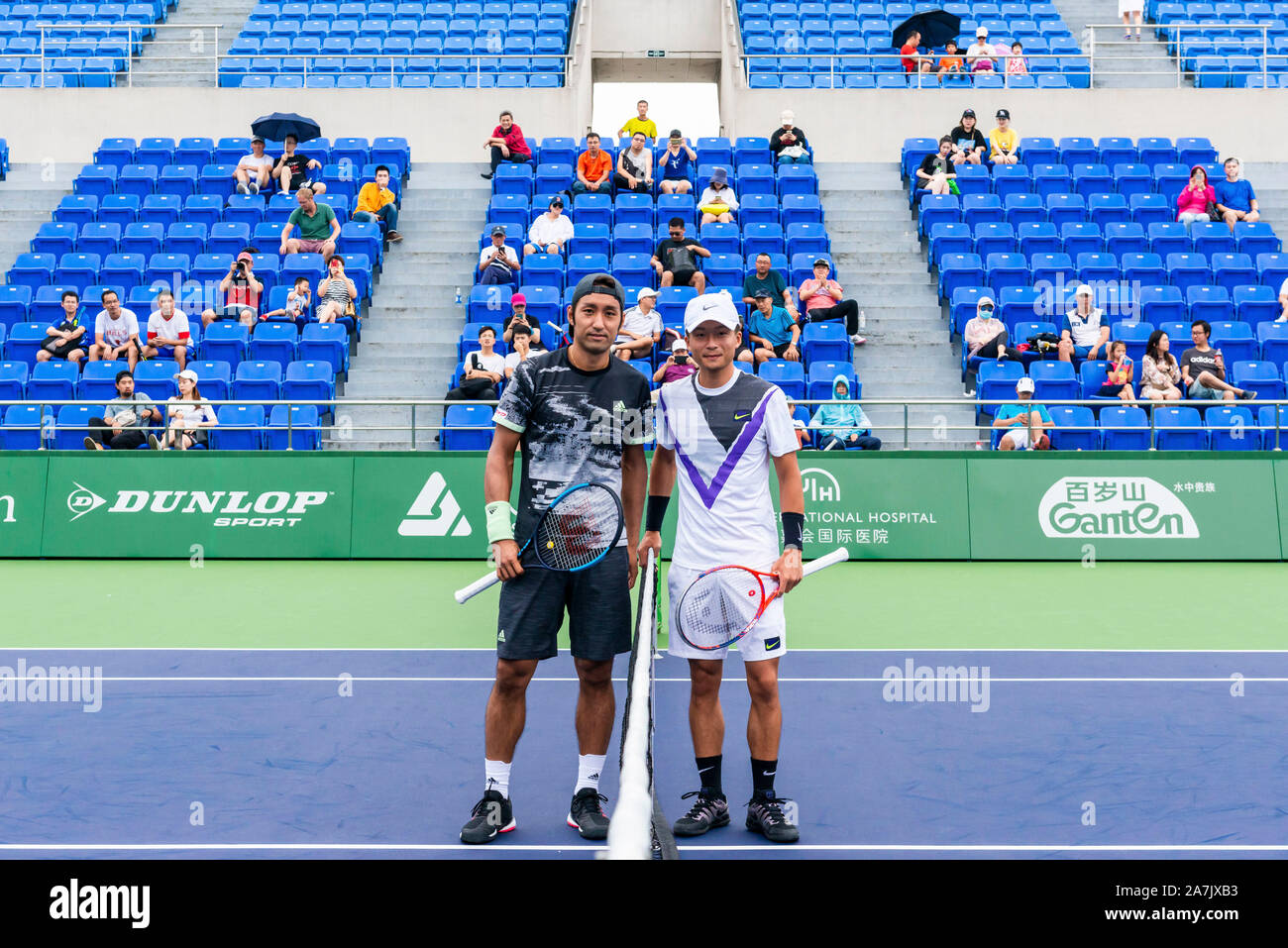 Japanese tennis player Yasutaka Uchiyama, left, takes pictures with