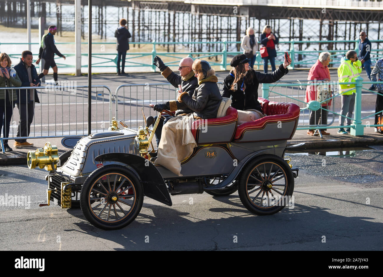 Brighton UK 3rd November 2019 - Time for a selfie as early arrivals near the finish of the Bonhams London to Brighton Veteran Car Run. Over 400 pre-1905 cars set off from Hyde Park London early this morning and finish at Brighton's Madeira Drive on the seafront : Credit Simon Dack / Alamy Live News Stock Photo