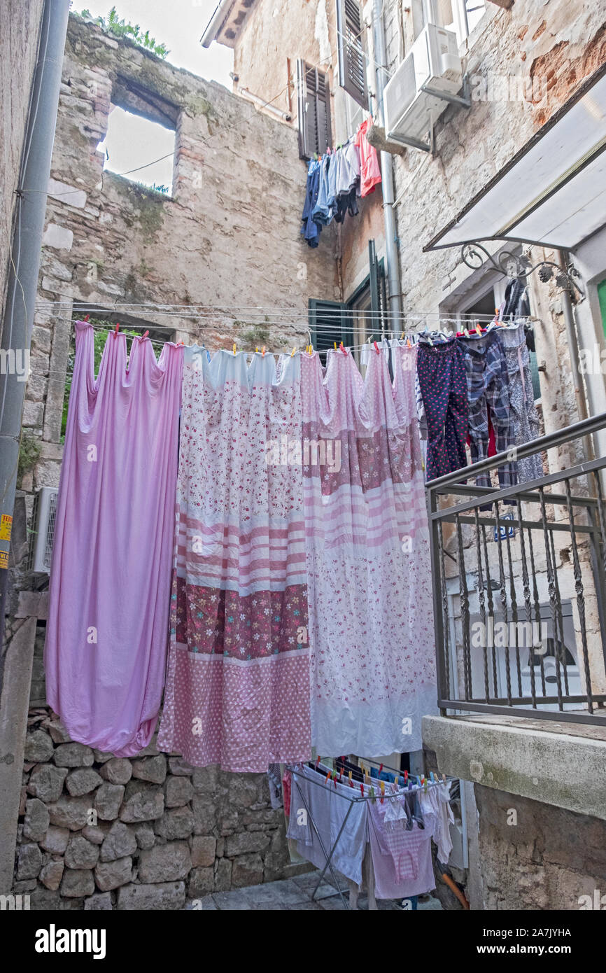Laundry hung out to dry in an alley in the old town section of Kotor Montenegro. Stock Photo