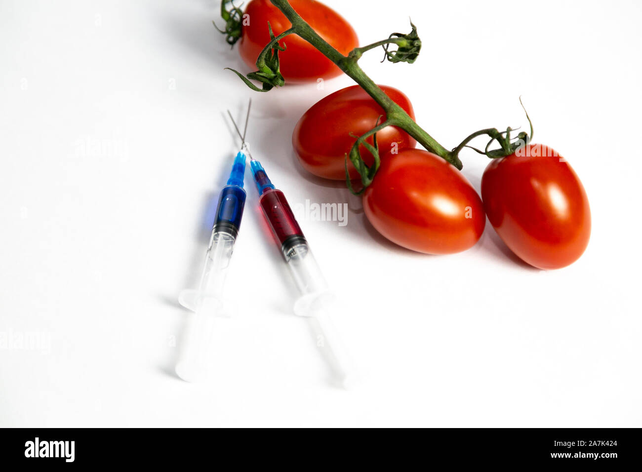 Syringes with chemicals for fertilizing tomatoes on a white background. Stock Photo