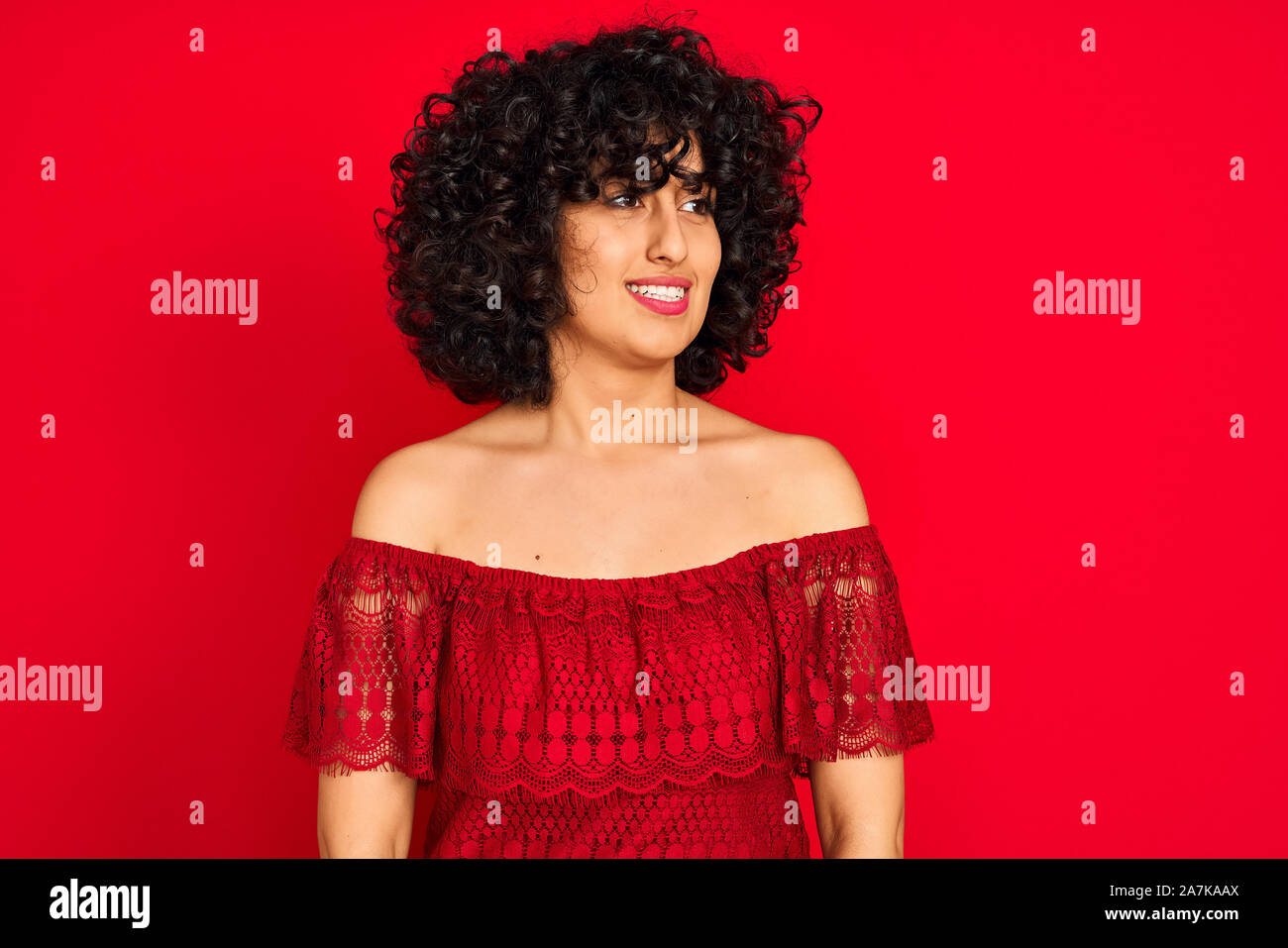 Young Arab Woman With Curly Hair Wearing Casual Dress Over