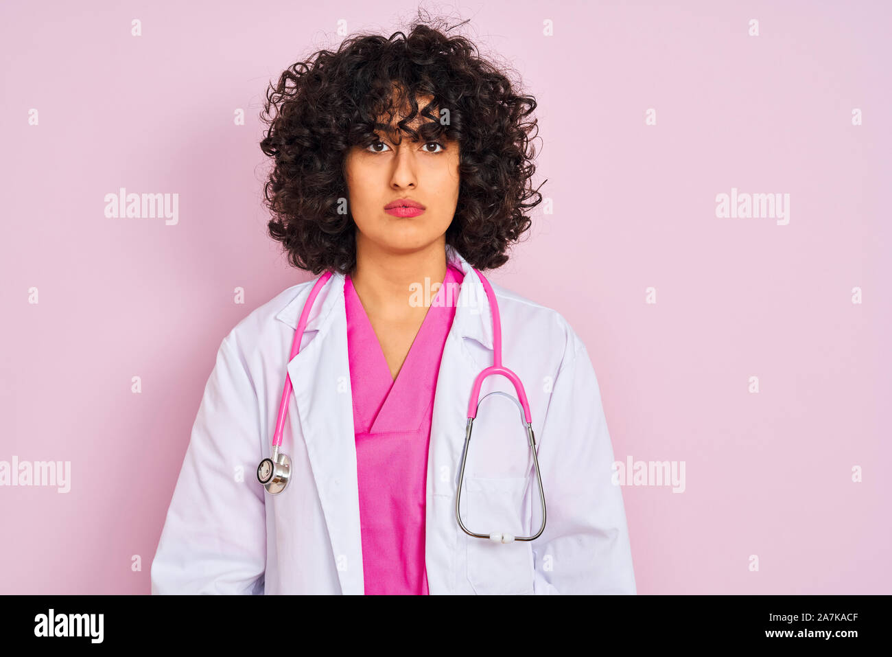 Young Arab Doctor Woman With Curly Hair Wearing Stethoscope Over