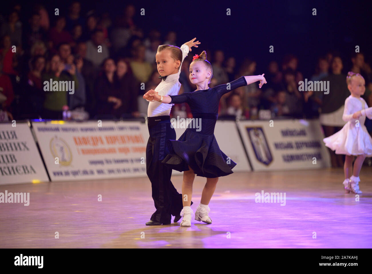 Little girls and boys dancing in couples in the ballroom. October 20