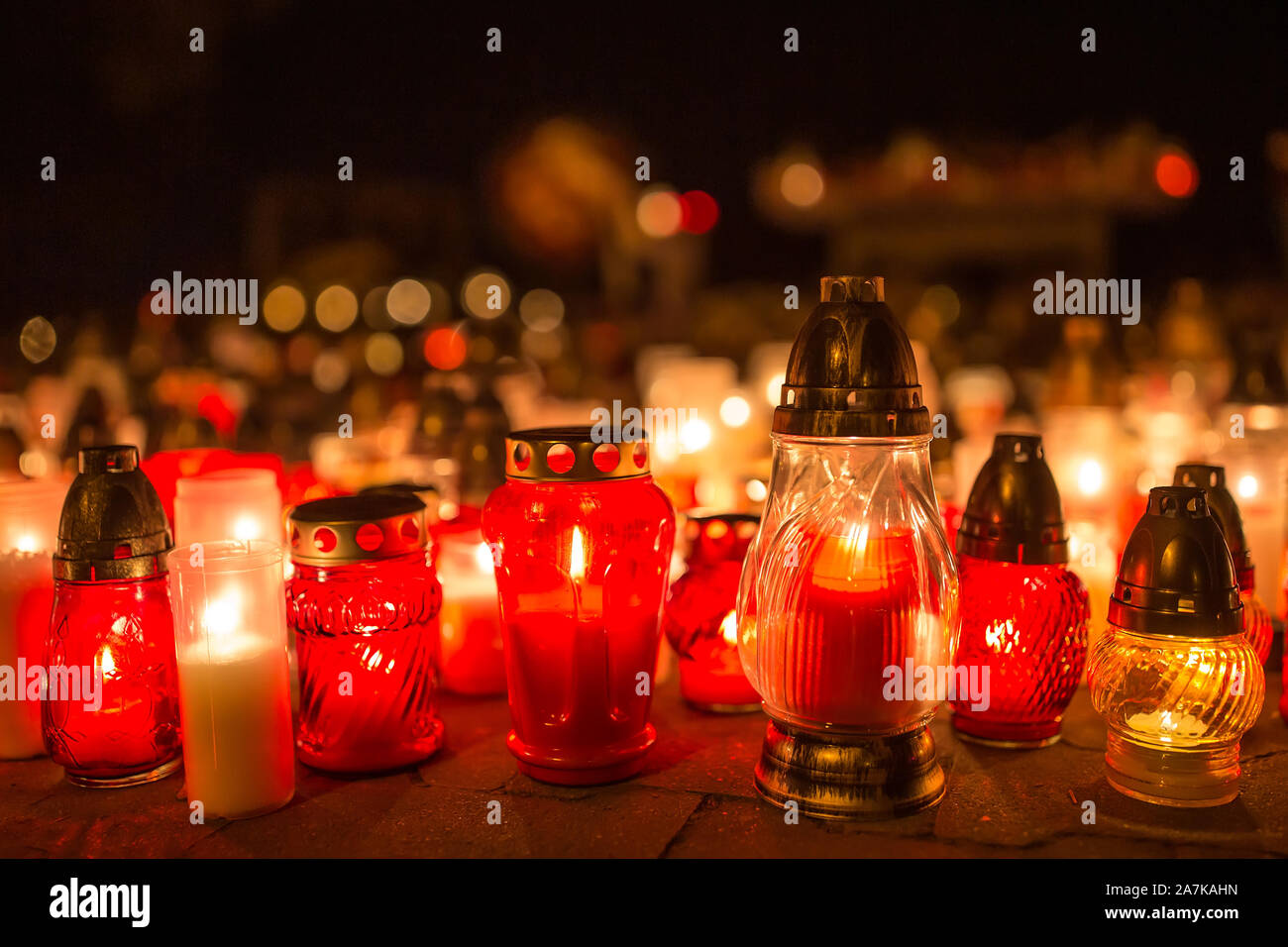 Many burning candles in the cemetery at night on the occasion souls of