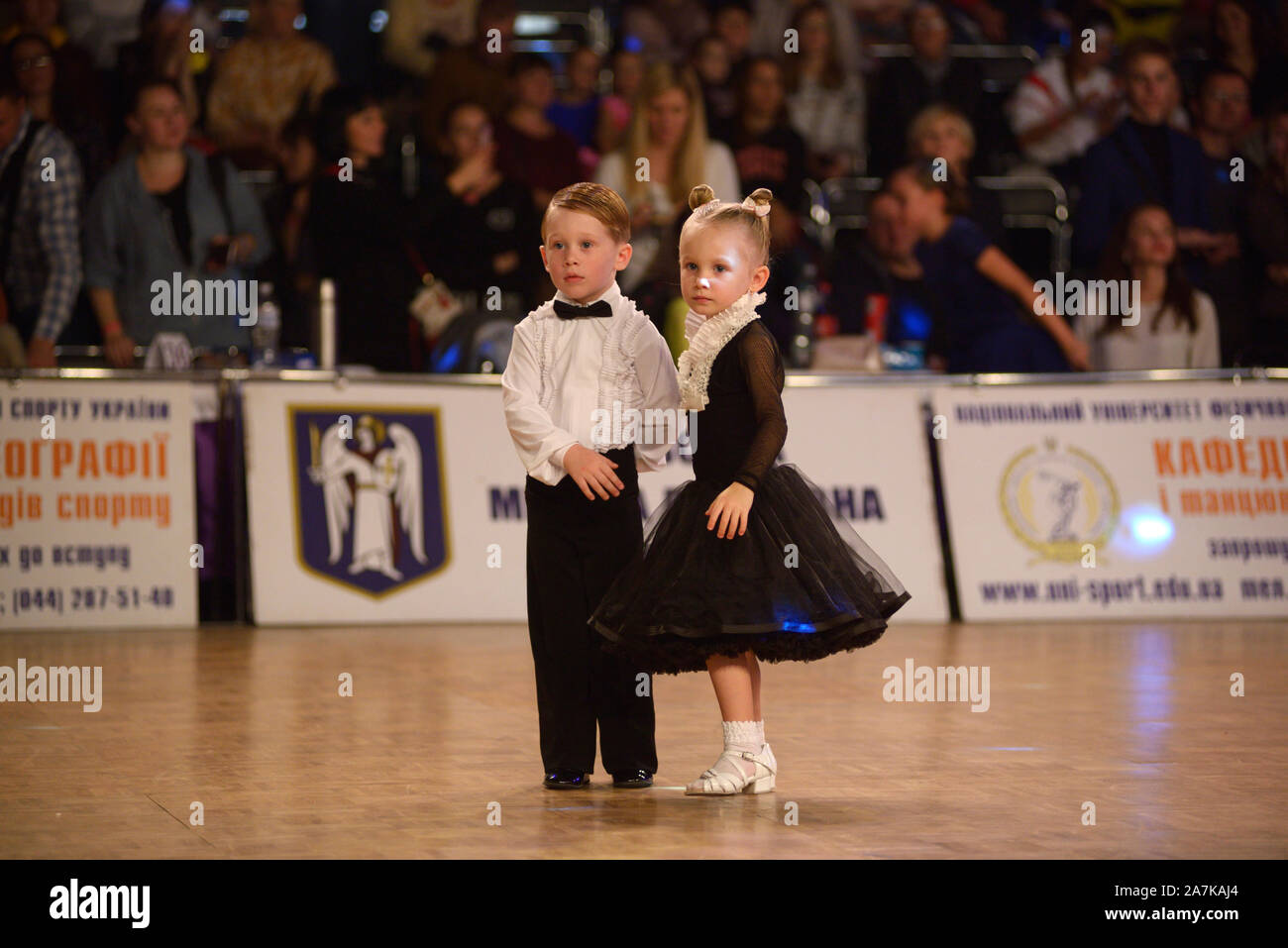 Little girls and boys dancing in couples in the ballroom. October 20