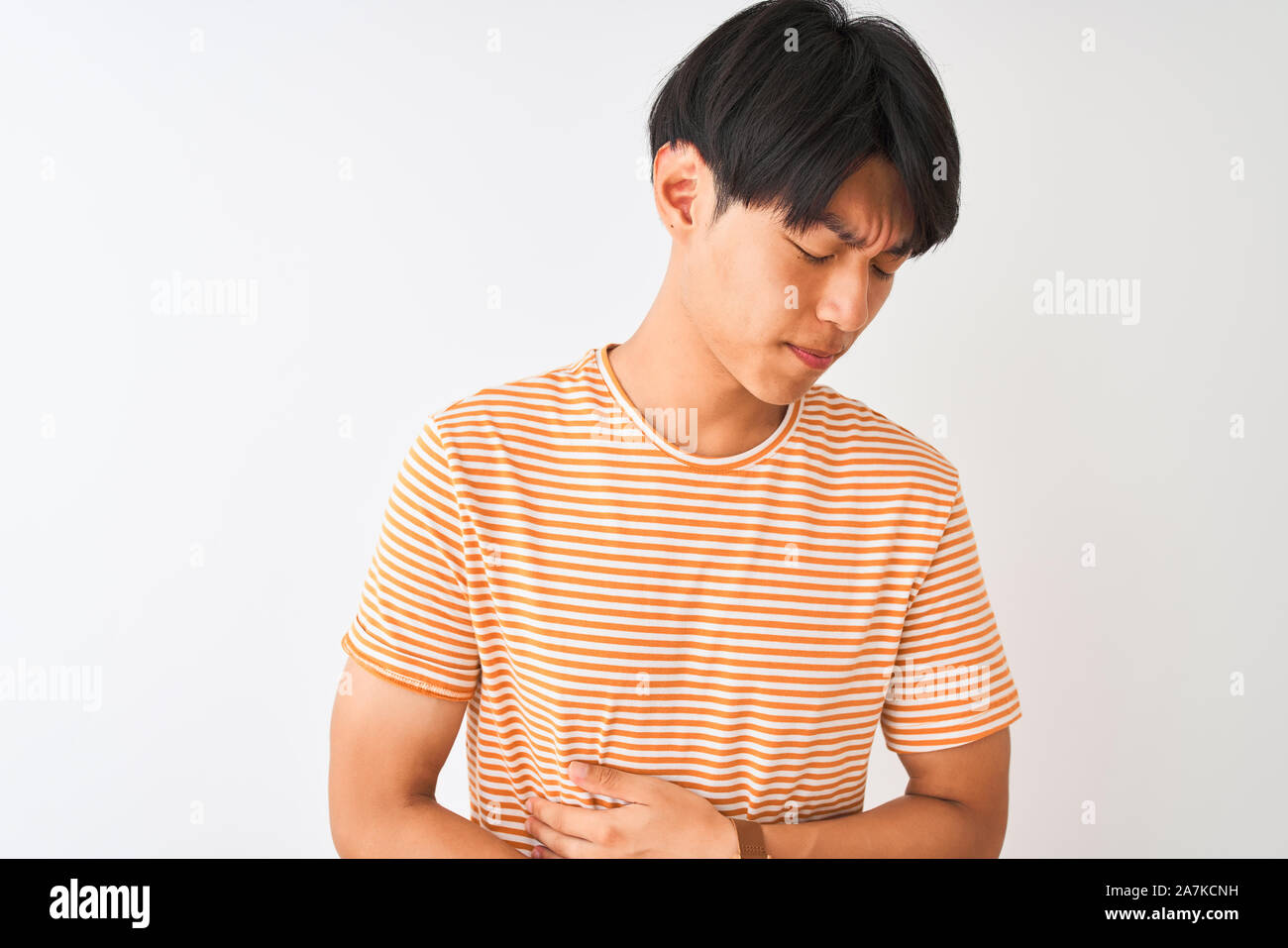 Young Chinese Man Wearing Casual Striped T Shirt Standing Over