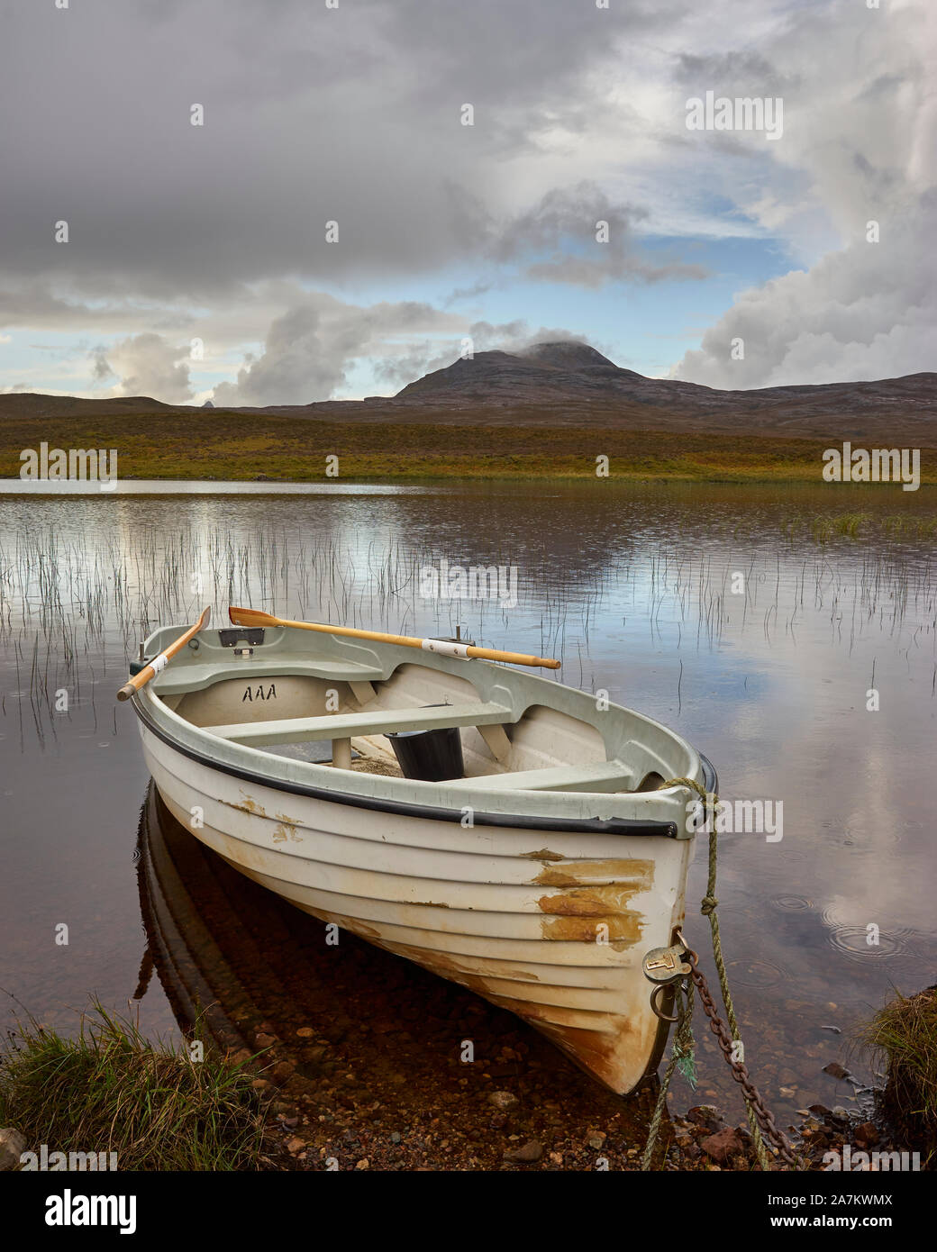 Rowing boat and Loch Awe with Canisp behind, Assynt, Sutherland, Highland, Scotland Stock Photo